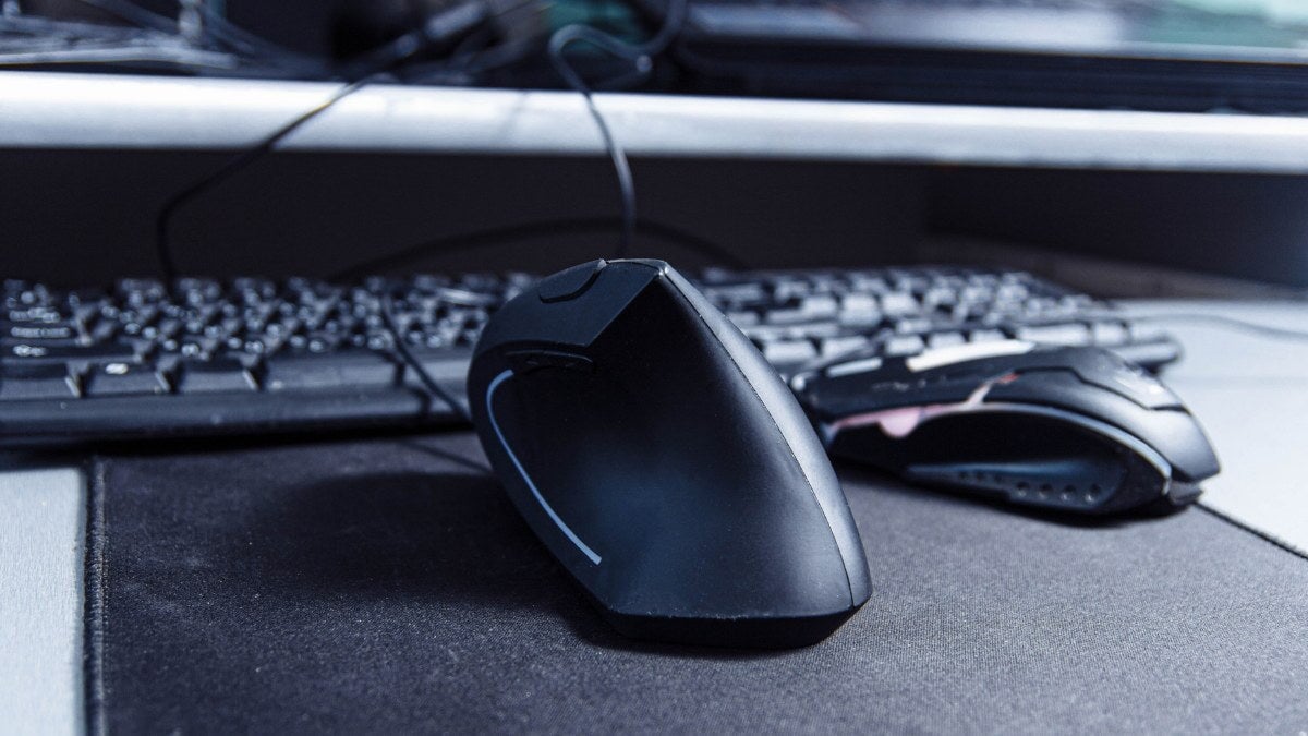 une souris ergonomique à côté d'un clavier